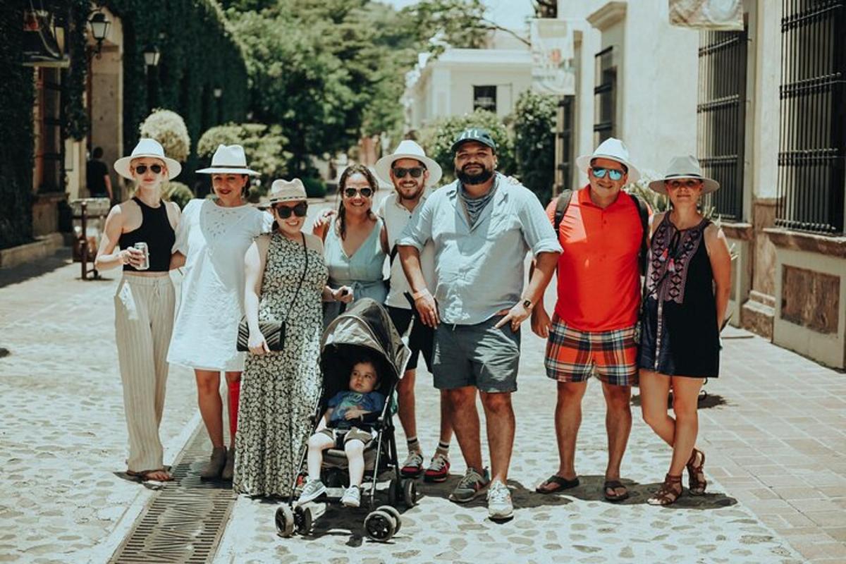 a group of people standing on a street with a baby in a stroller