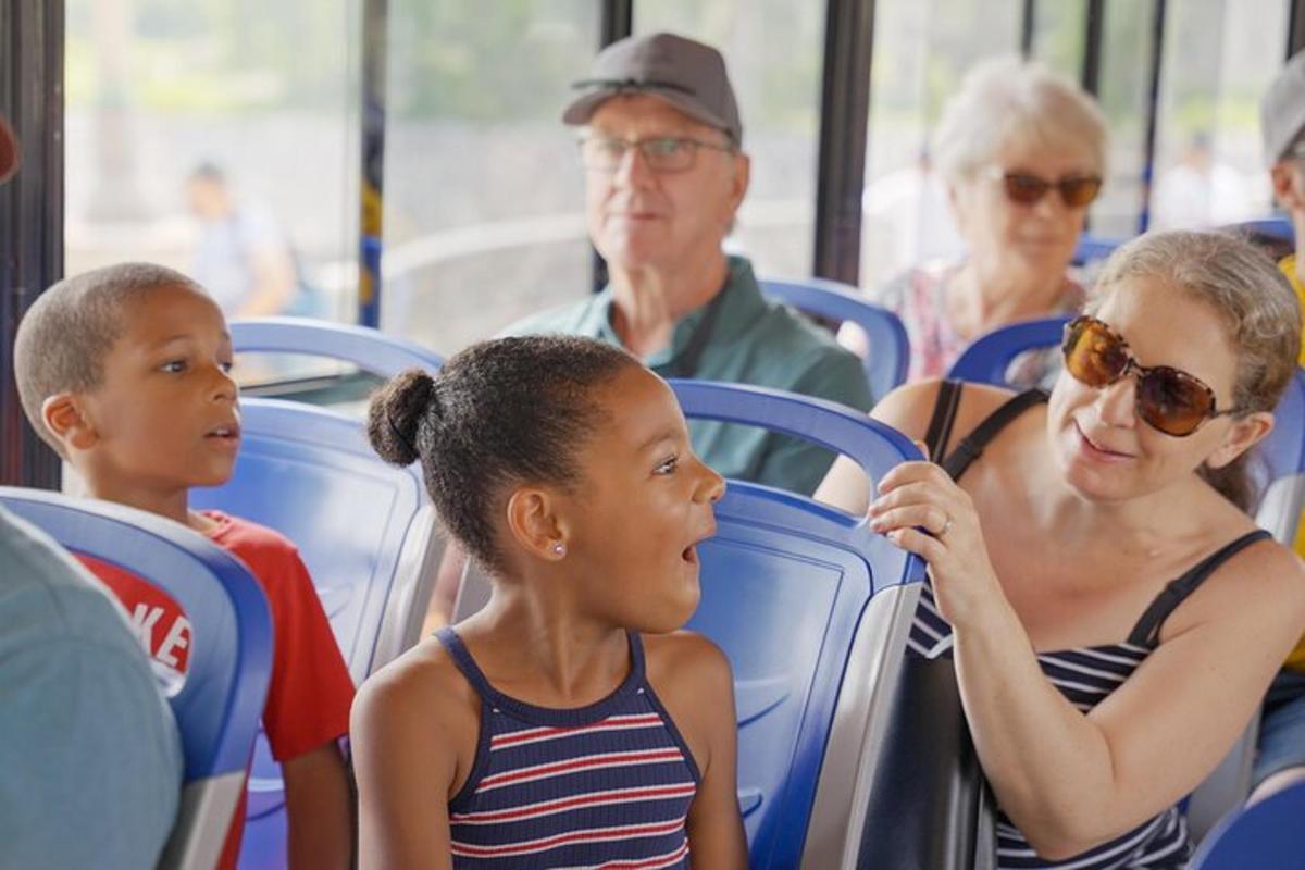 a woman and two children sitting on a bus