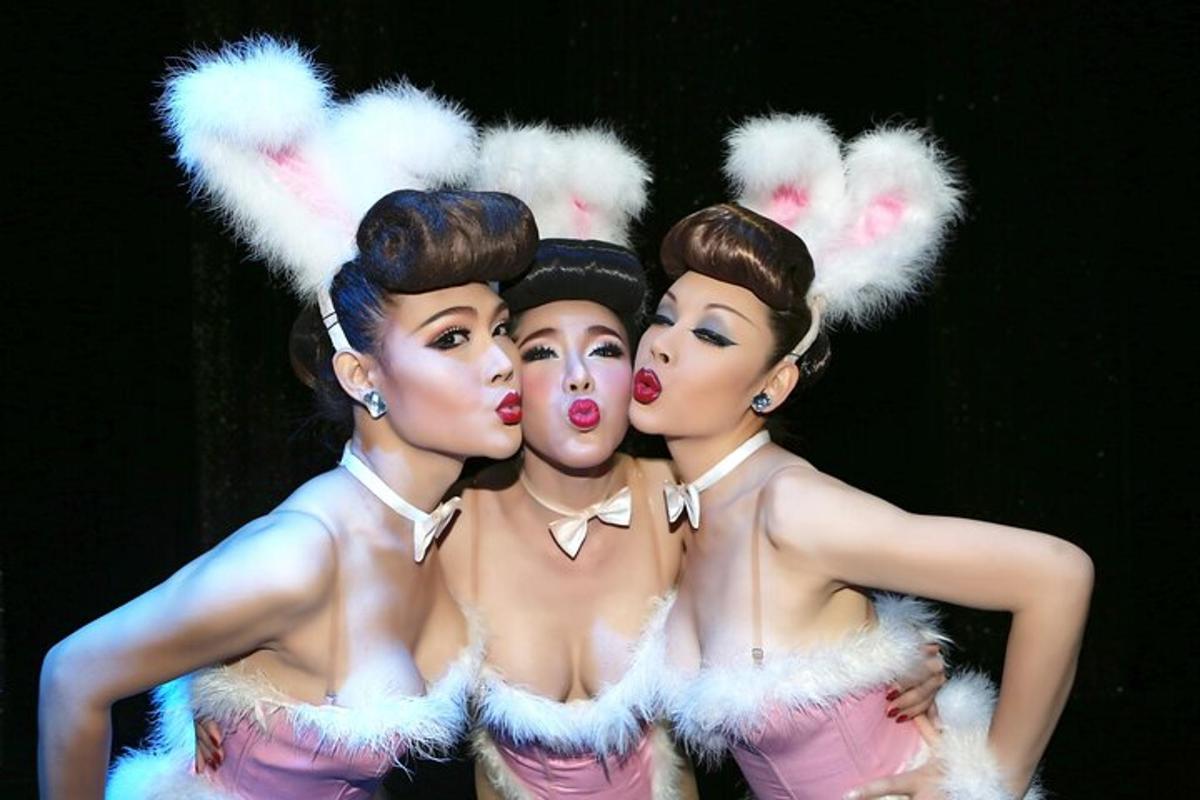 a group of three women standing next to each other