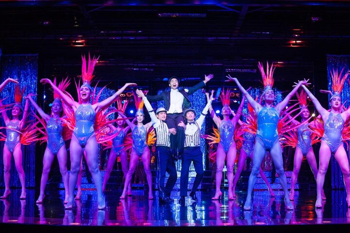 a group of dancers on the stage with a man