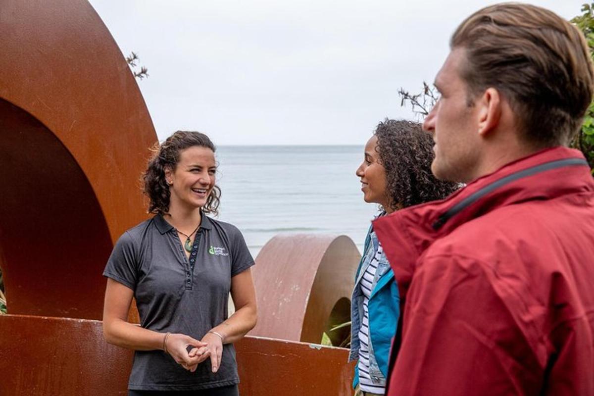 a group of three people standing next to a surfboard