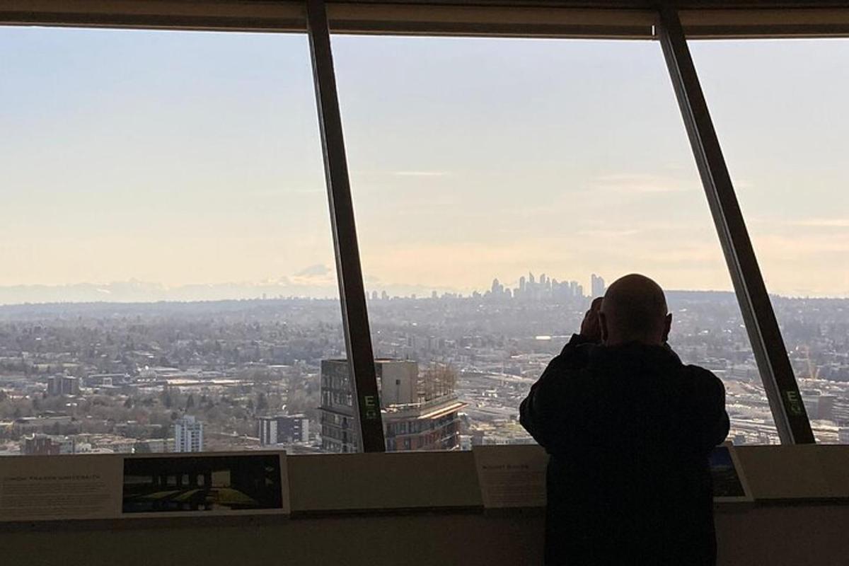 a person taking a picture of a city from a window