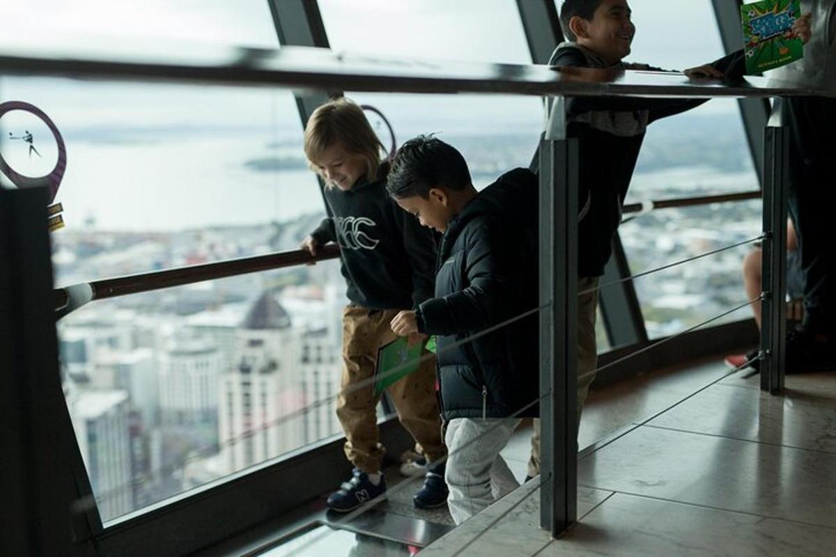 three boys standing on the top of a building