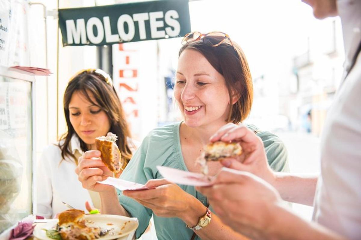 two women sitting at a table eating food