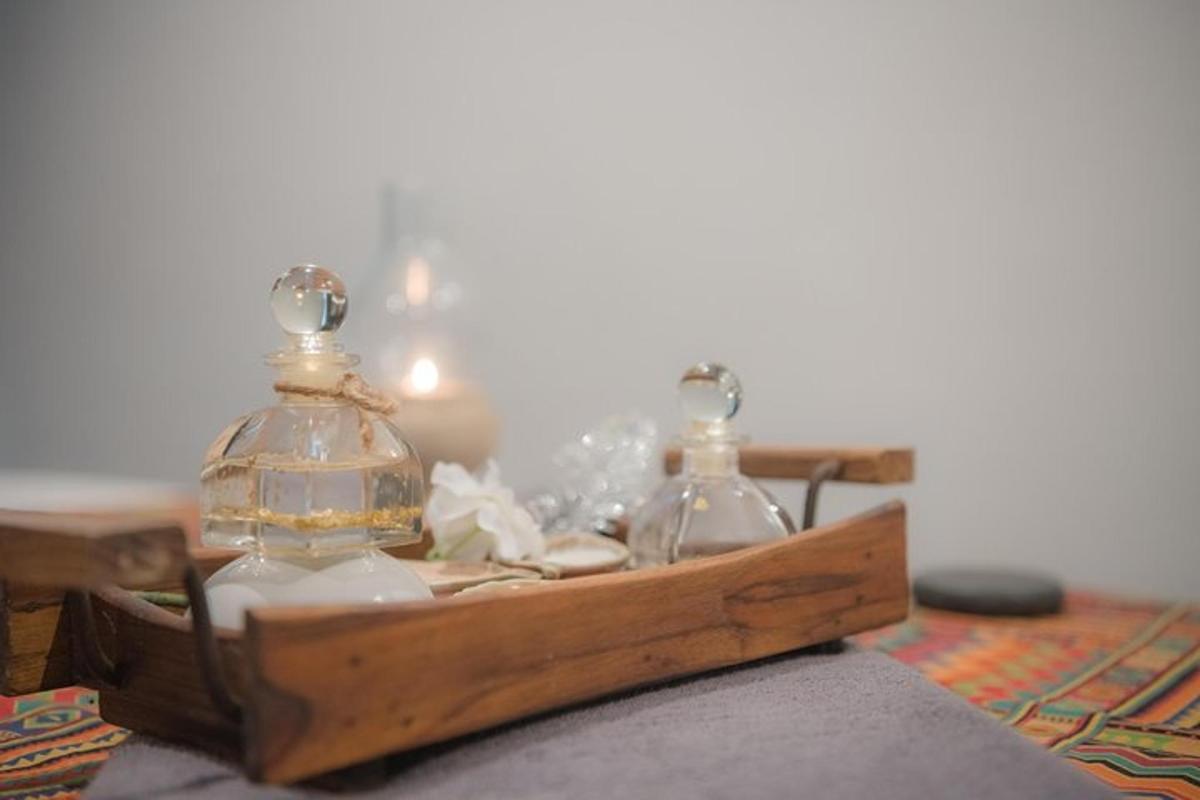two glass jars in a wooden box on a table
