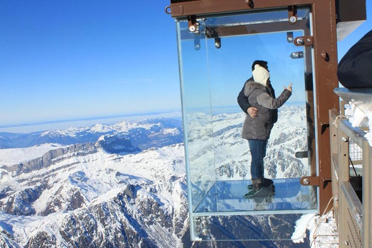 a person is standing on top of a glass wall