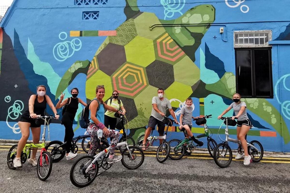 a group of people on bikes in front of a mural