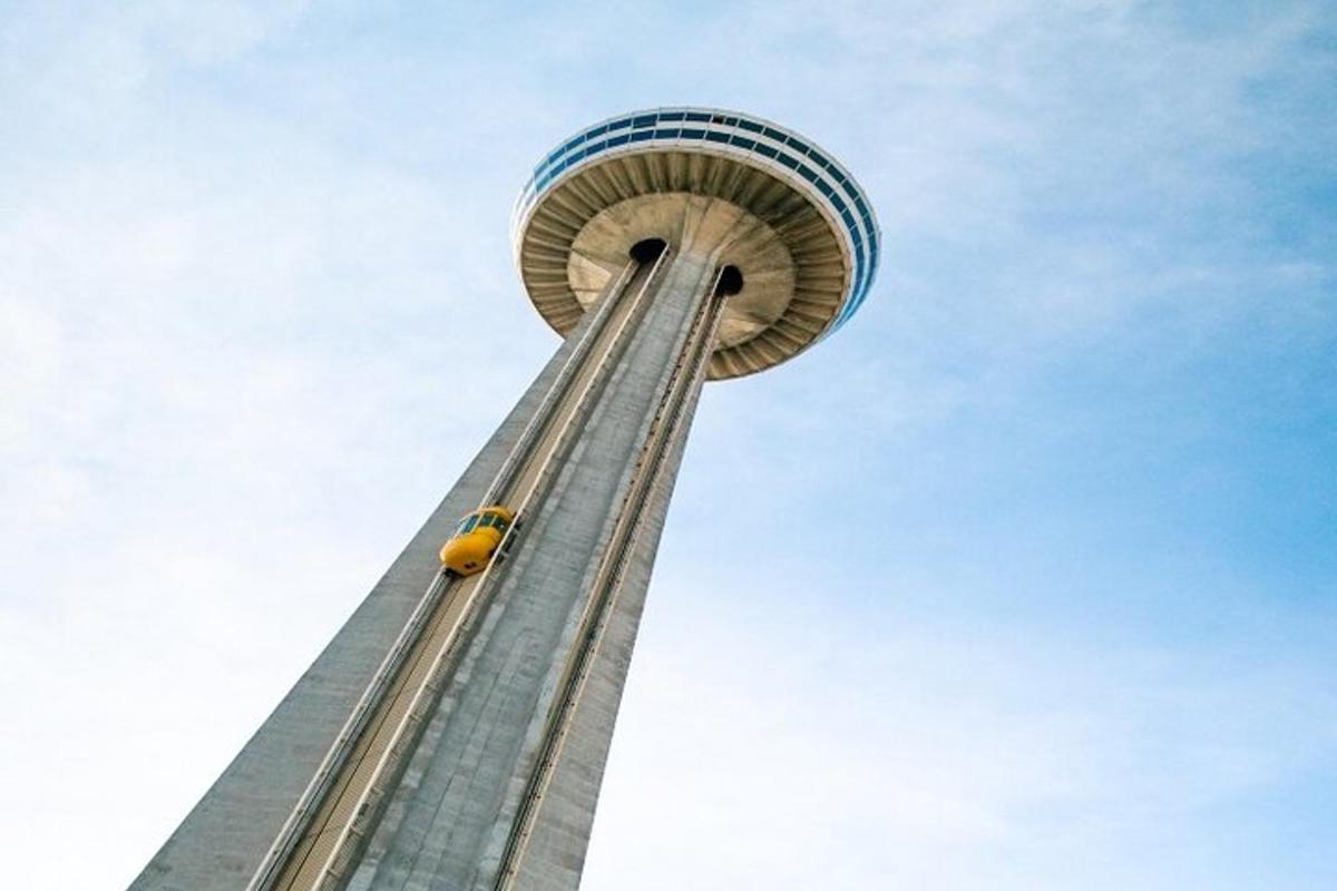a tall tower with a yellow car at the top