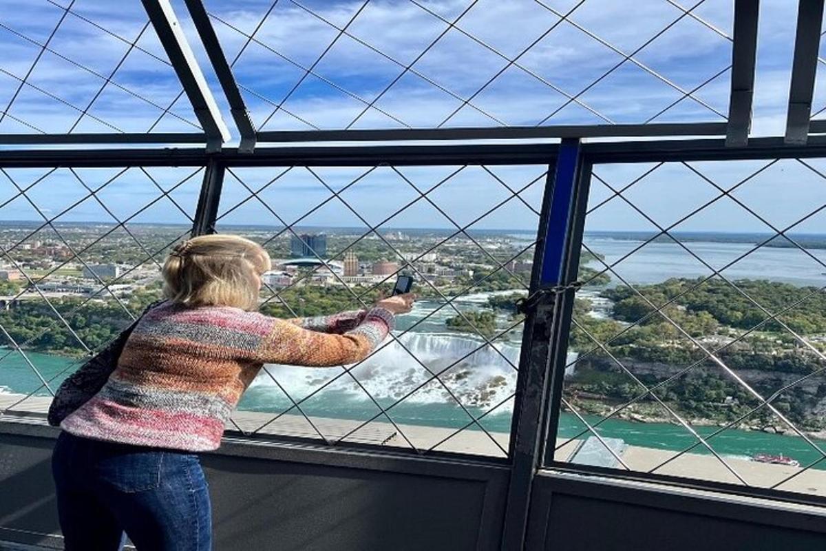 a woman taking a picture of the view from a window
