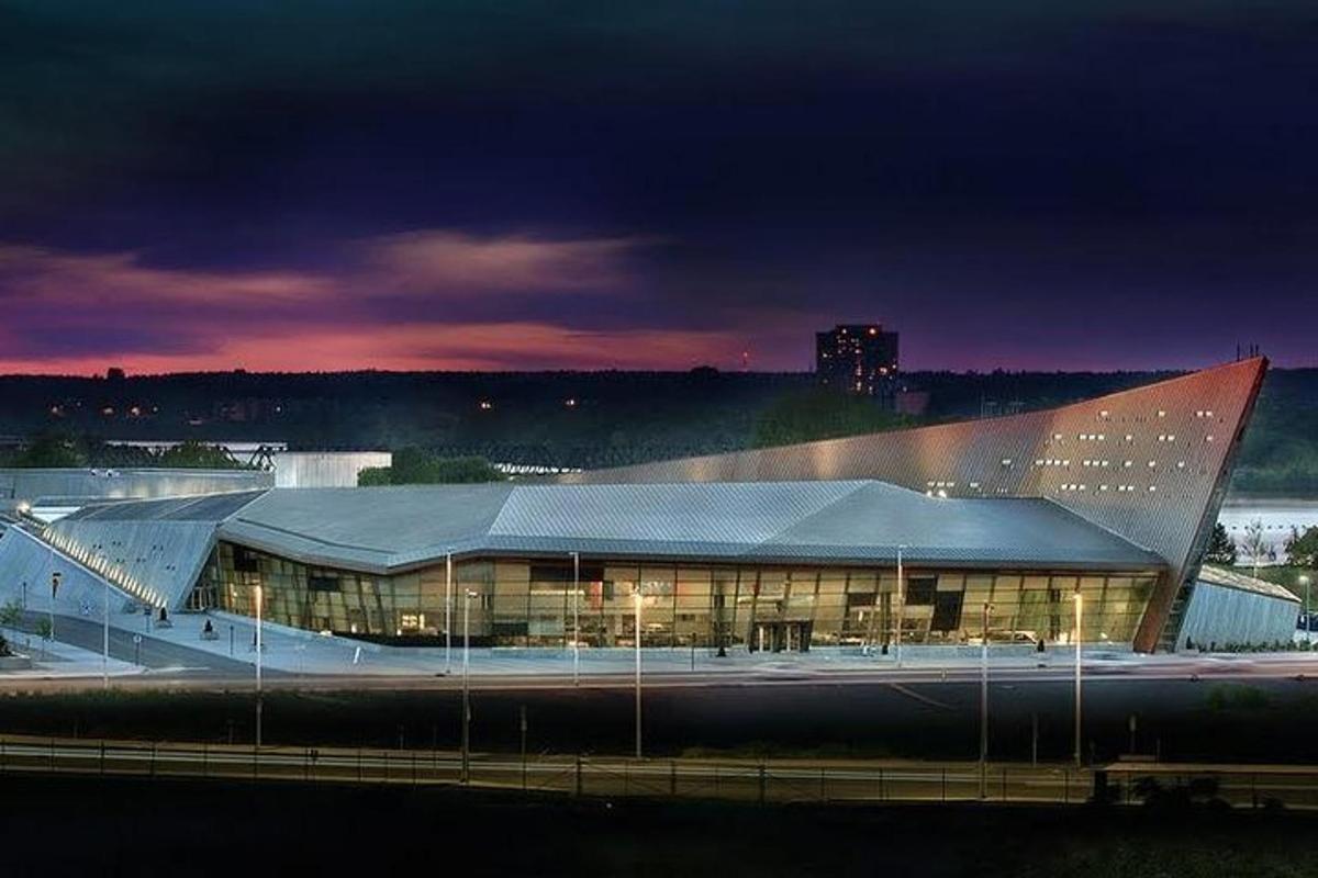 a large building with a large roof at night