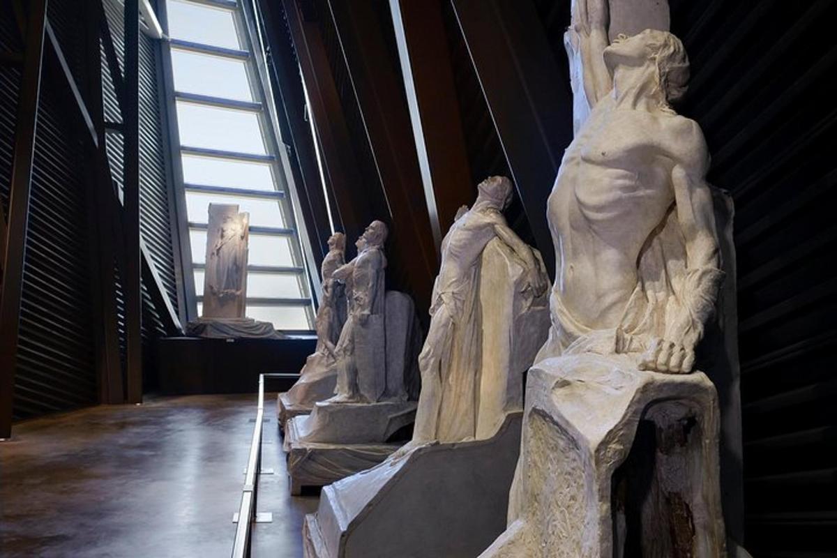 a statue in a museum with other statues