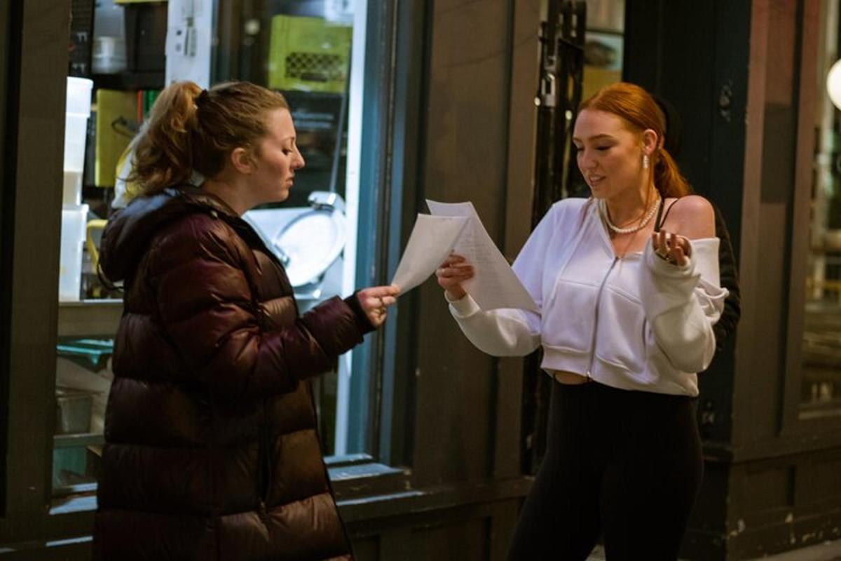 two women are looking at a piece of paper