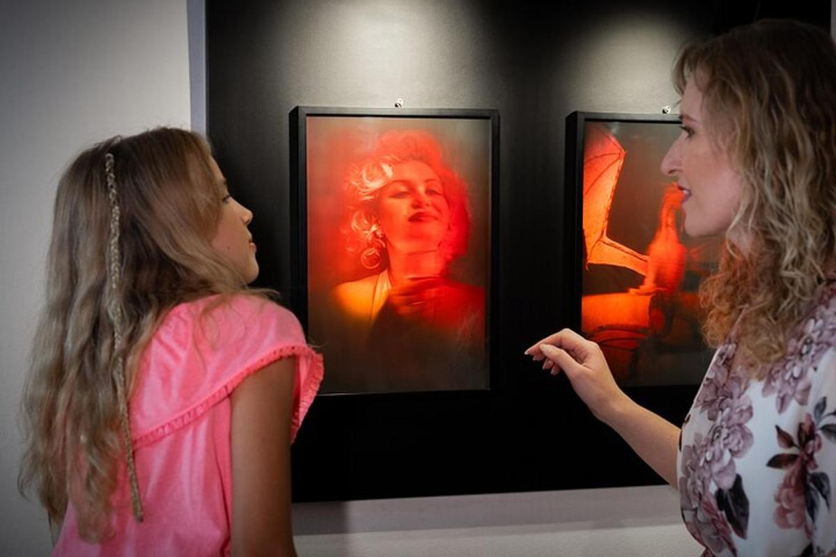 a young girl looking at a picture of a woman