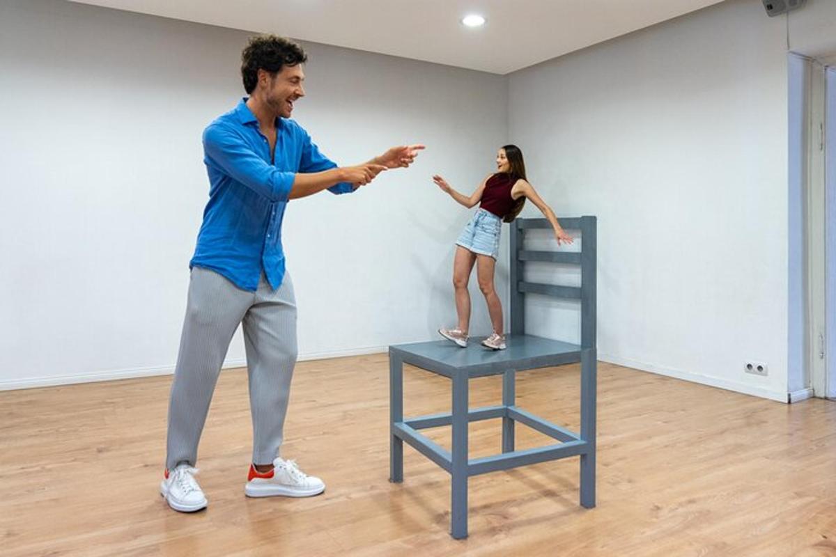a man and a woman standing next to a chair