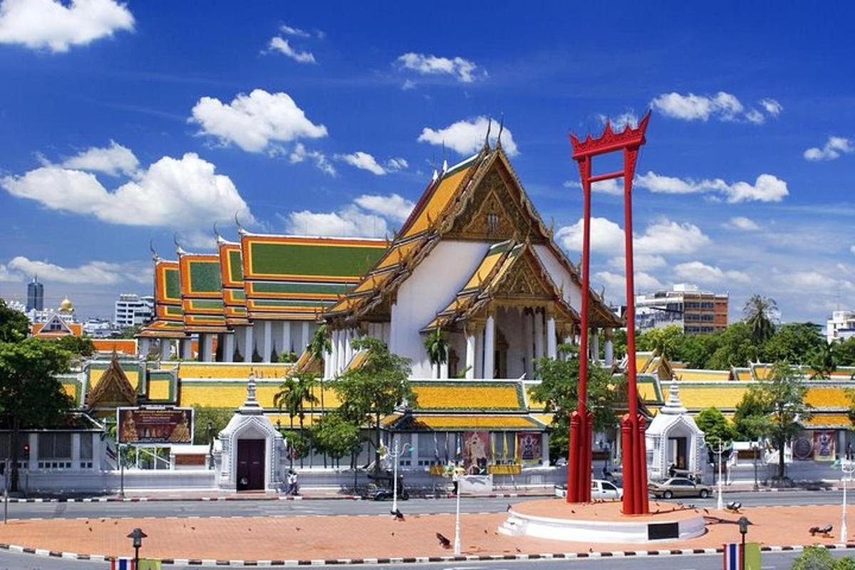 a large building with a red sculpture in front of it
