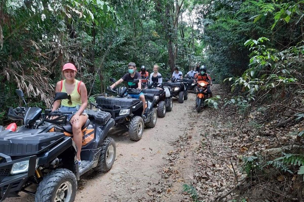 a group of people riding atvs on a dirt road