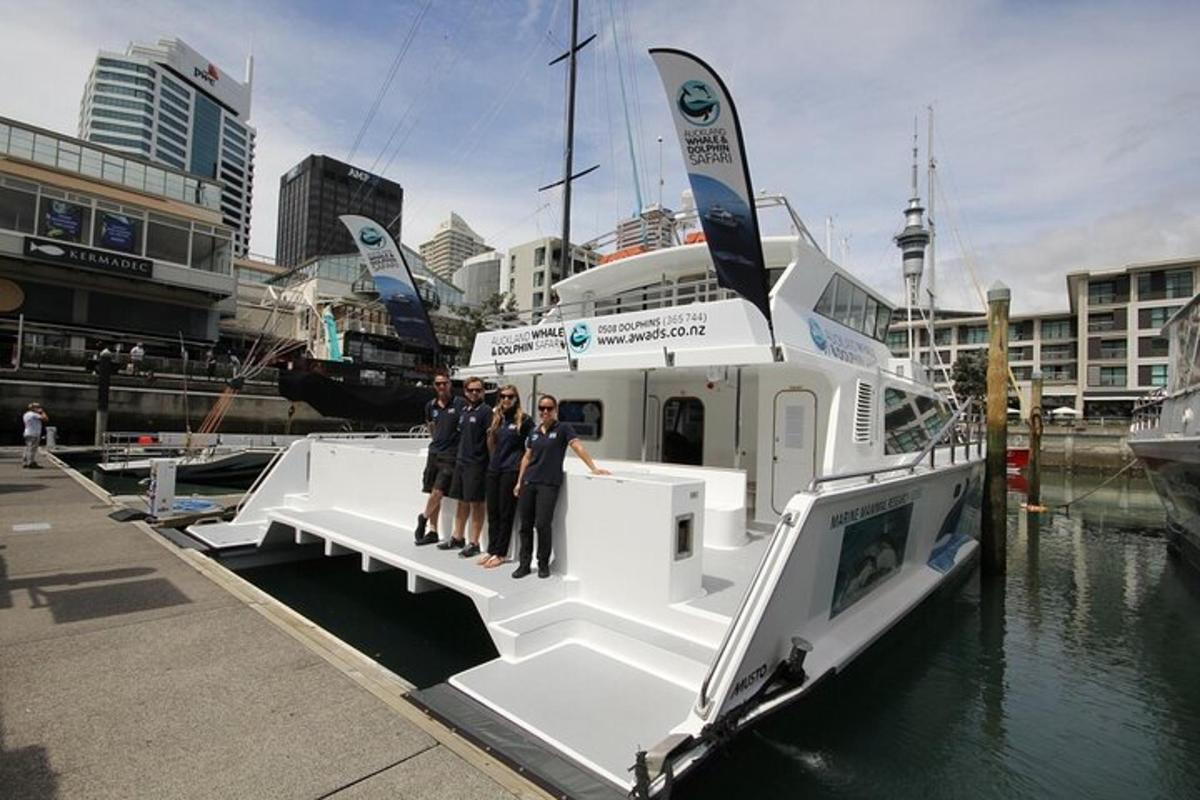a group of people standing on a boat in the water