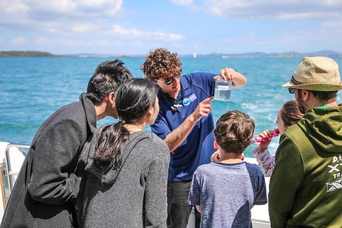 a man standing on a boat with a group of people