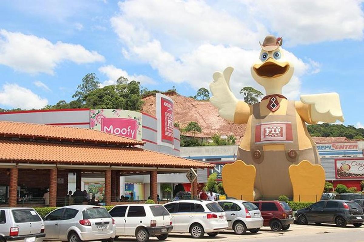 a large balloon of a chicken in a parking lot