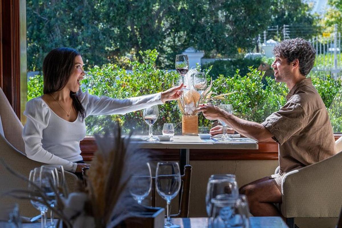 a man and woman holding up glasses of wine