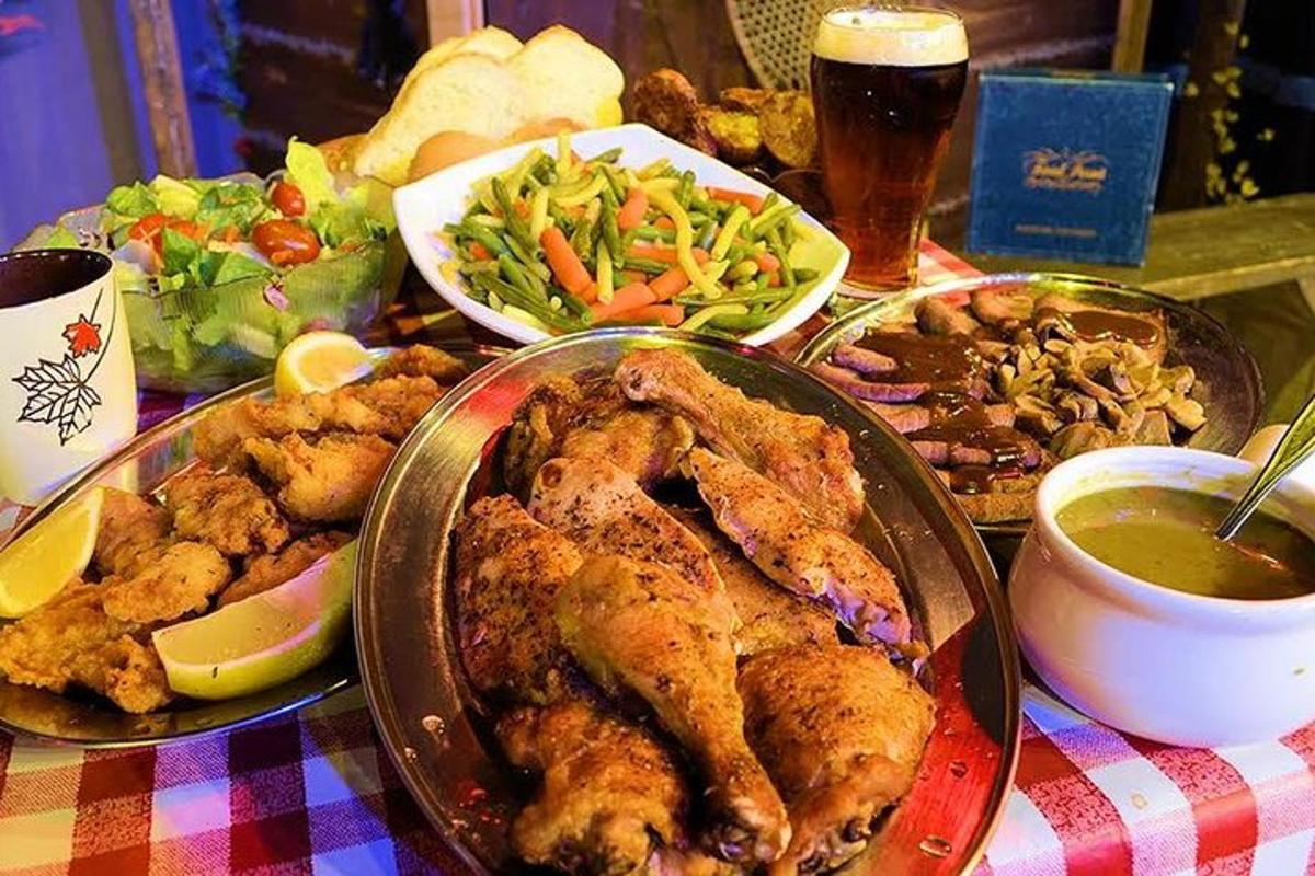 a table topped with chicken and a plate of food