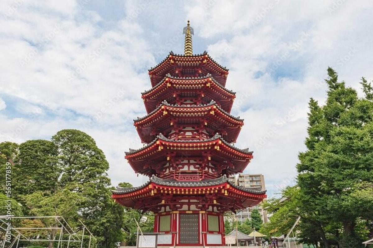 a large pagoda in a park with a sky