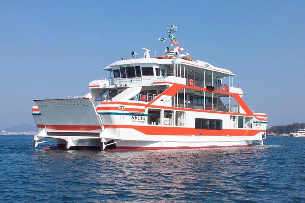 a red and white boat sitting in the water