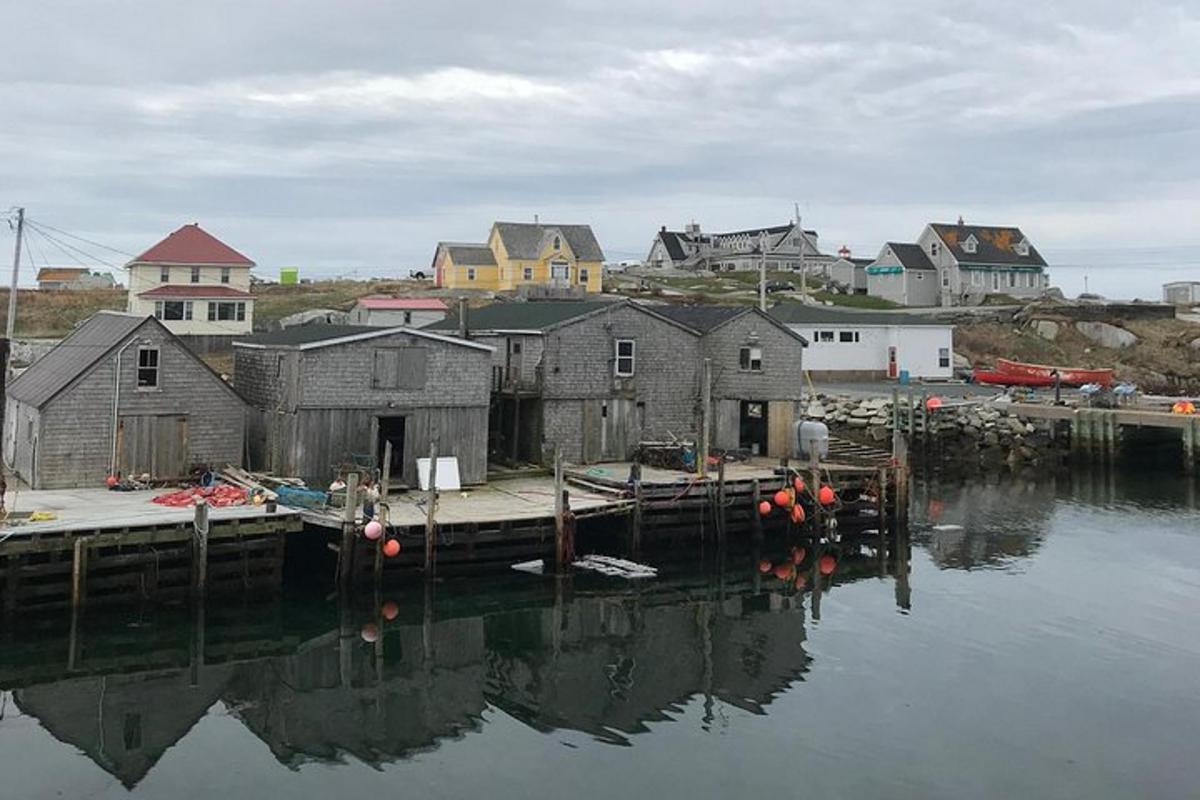 a group of houses on the water next to a dock