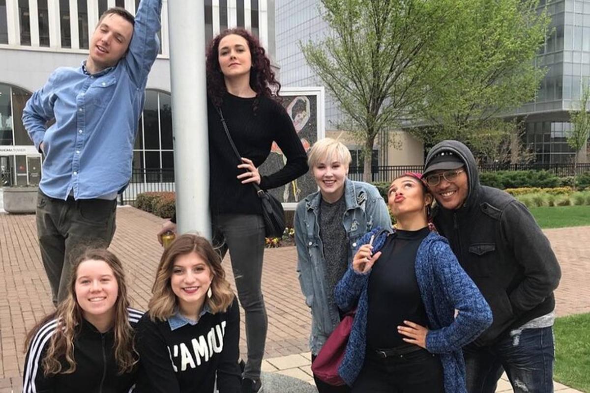 a group of people standing around a pole
