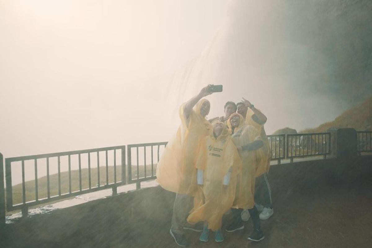 a group of people posing for a picture in the rain