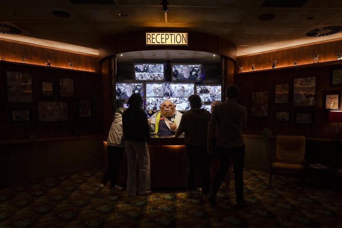 a group of people standing in a bar watching a television