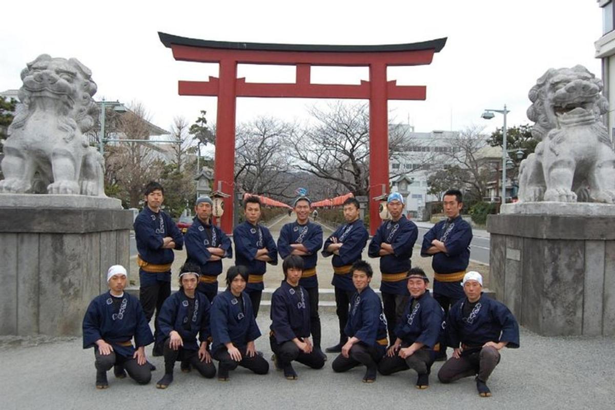 a group of men in uniform posing in front of a gate
