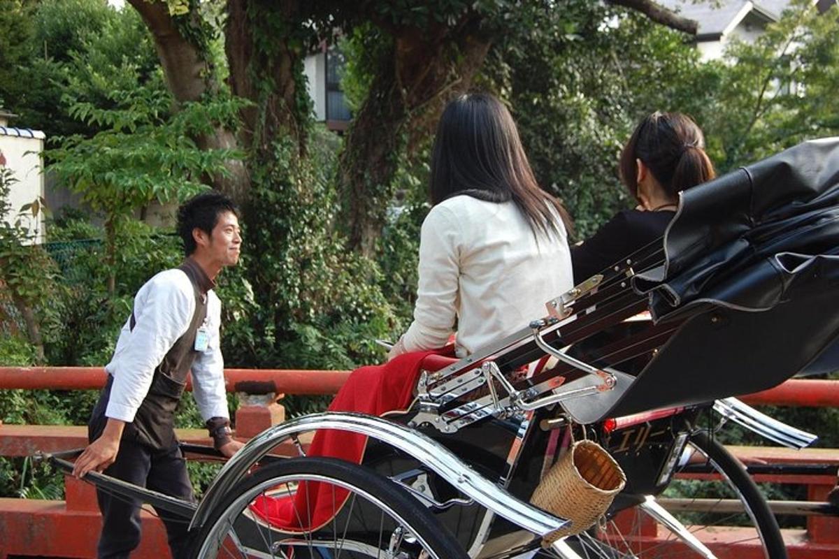 a group of people walking by a bench with a carriage