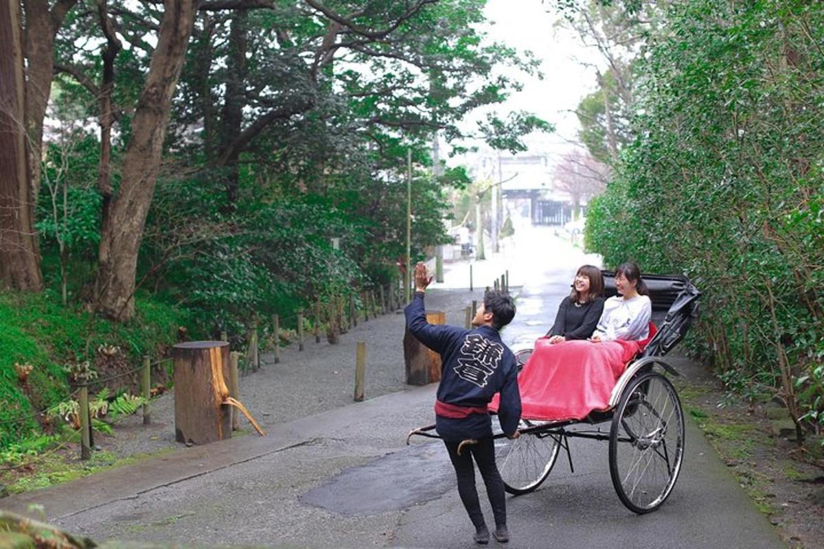 a man pushing a horse drawn carriage with two people