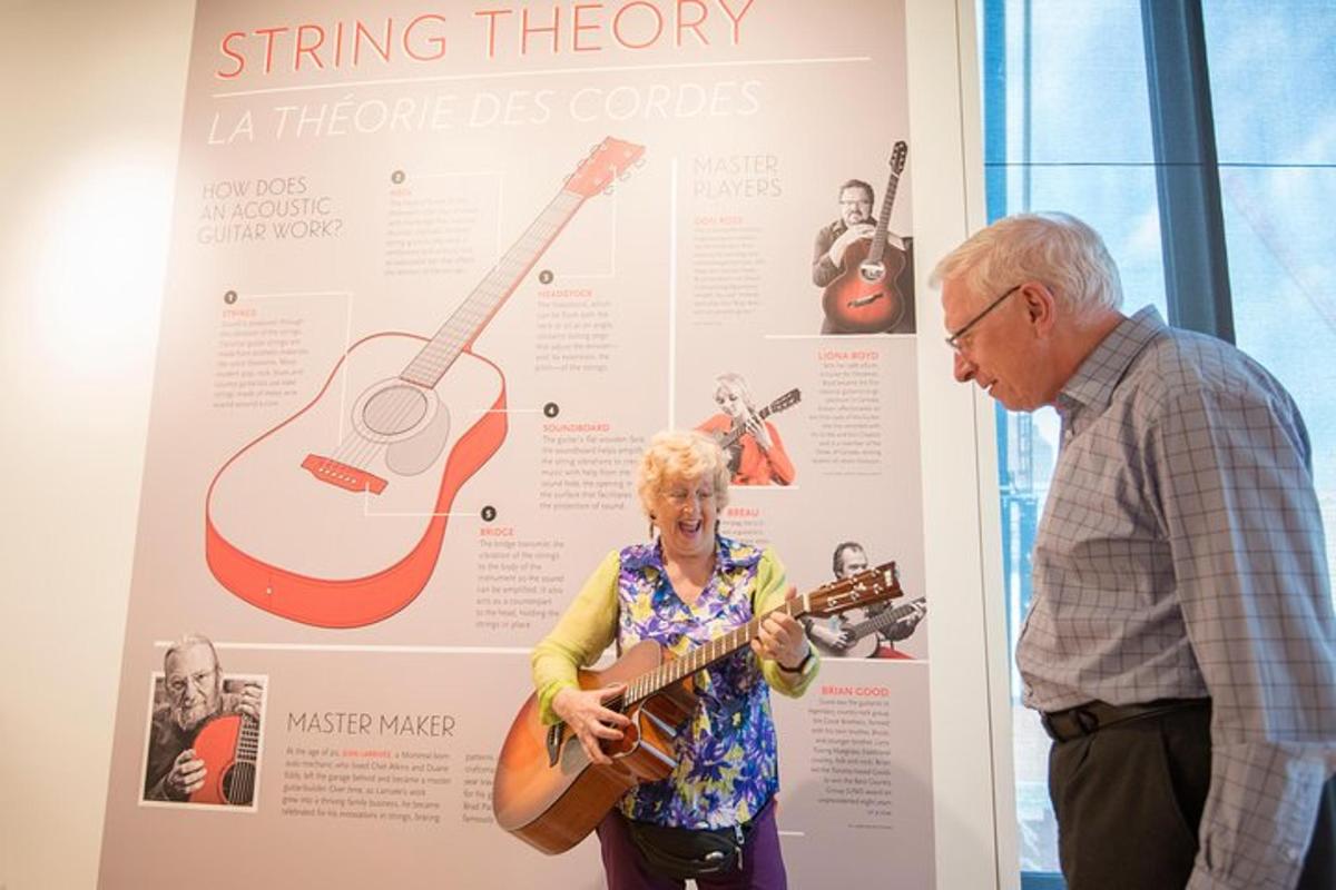 a man and a woman looking at a guitar display