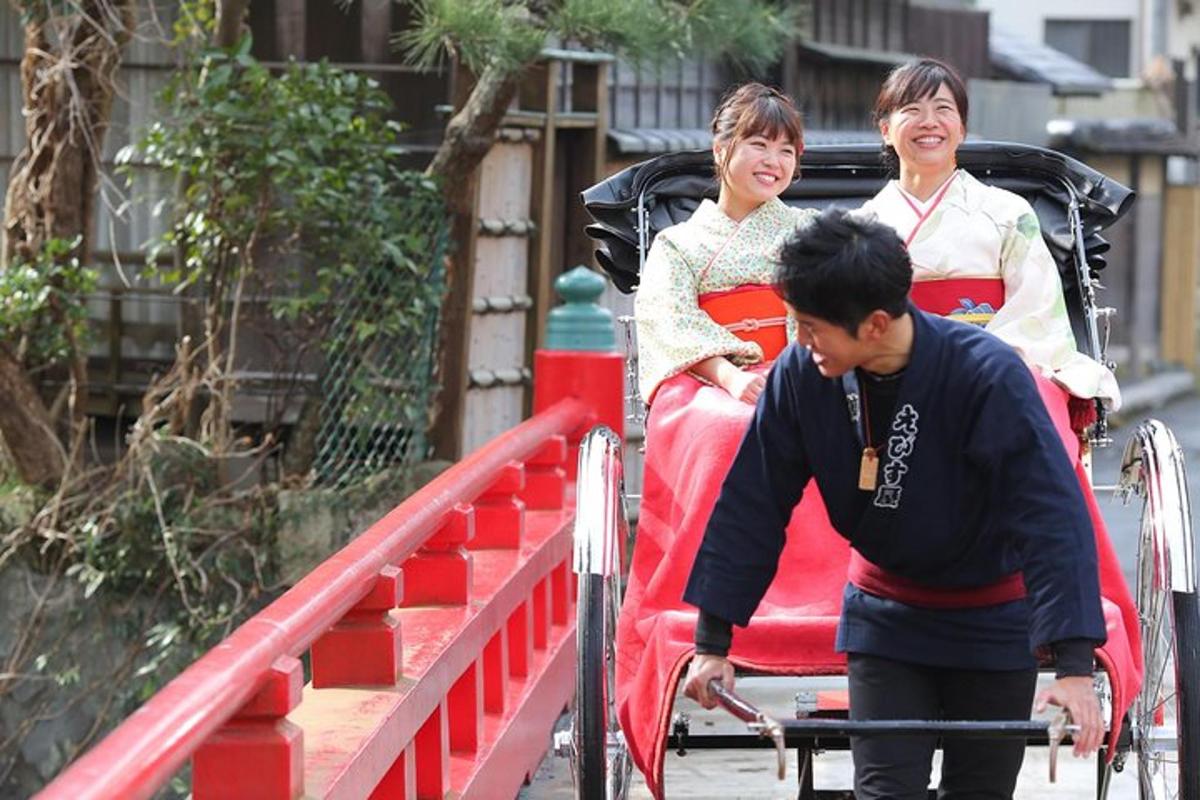 a man pushing a red carriage with two women