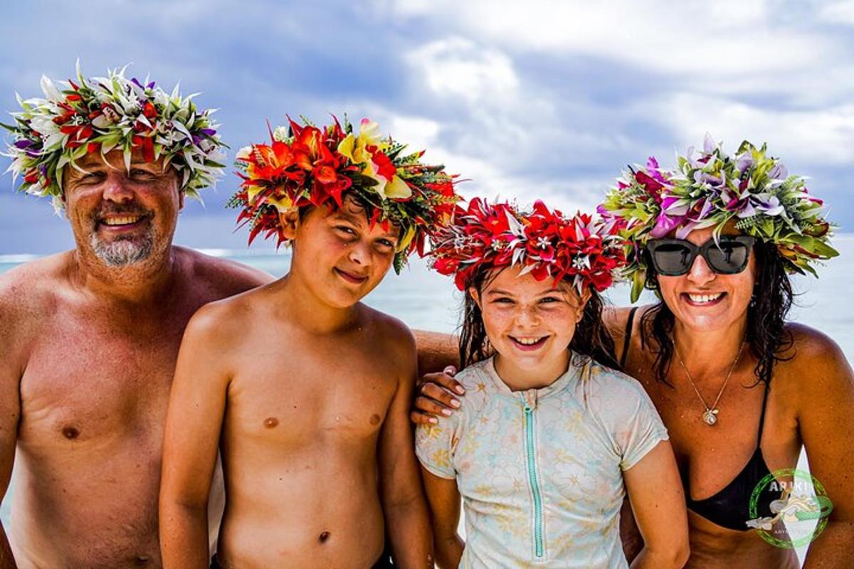 a group of people wearing flower hats on the beach