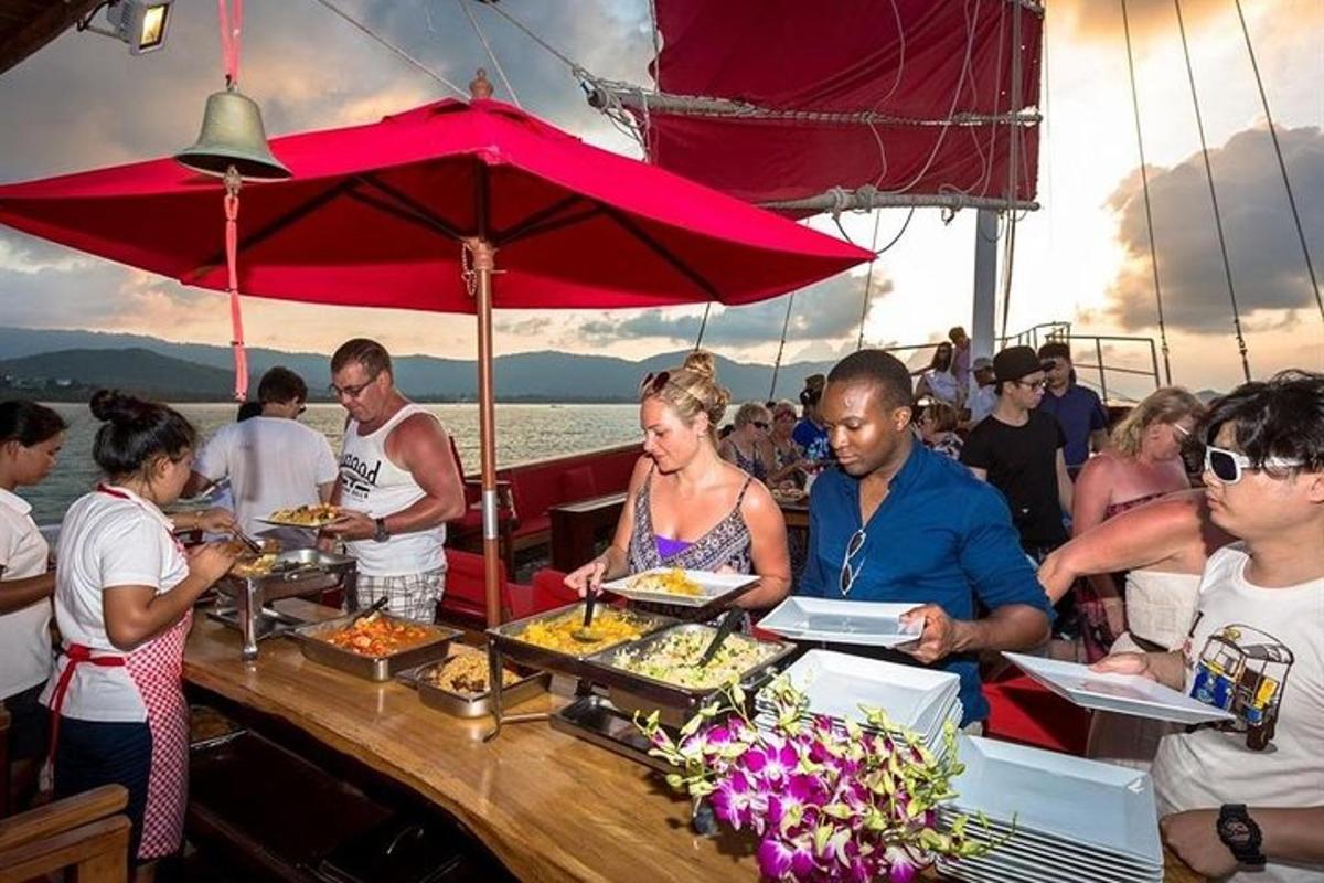a group of people eating food on a boat