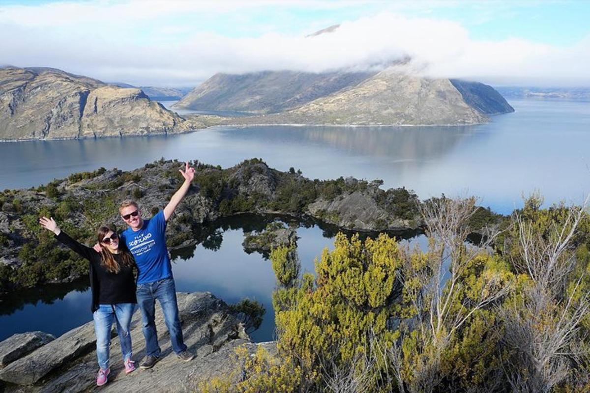 a man and a woman standing on top of a mountain