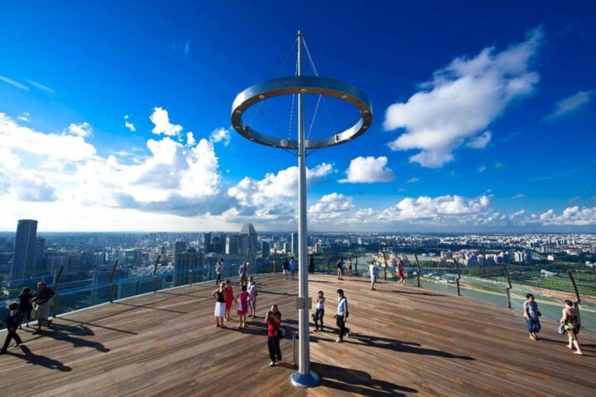 a group of people walking on the observation deck of a skyscraper