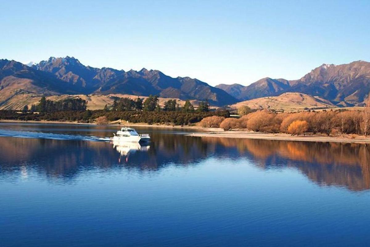 a boat on a river with mountains in the background