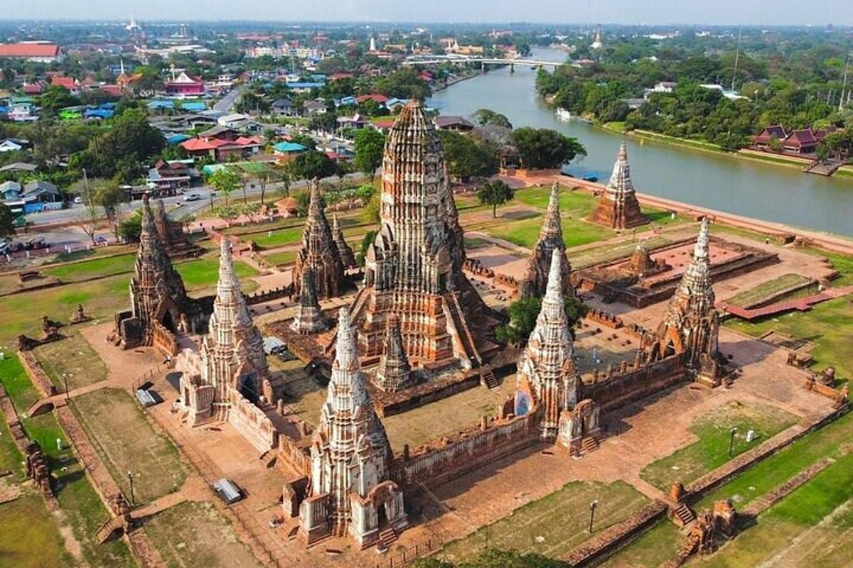 an aerial view of a temple near a river