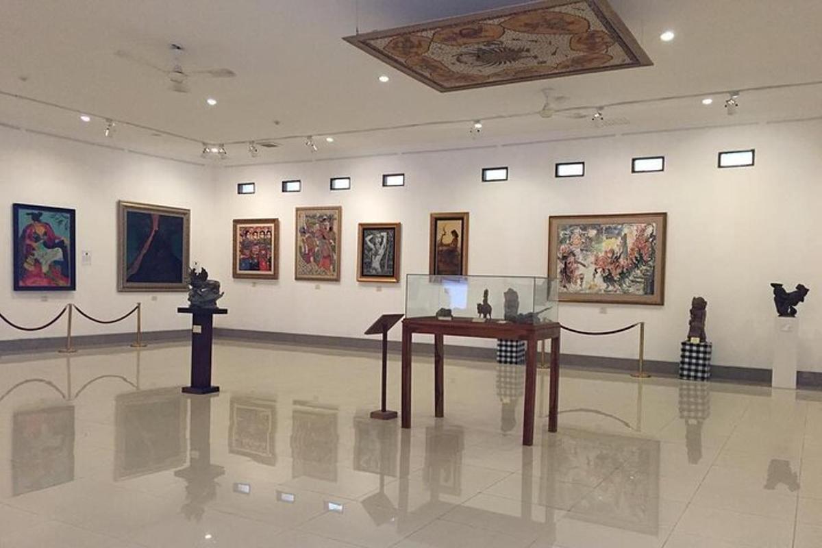 a museum with a table in a room with paintings