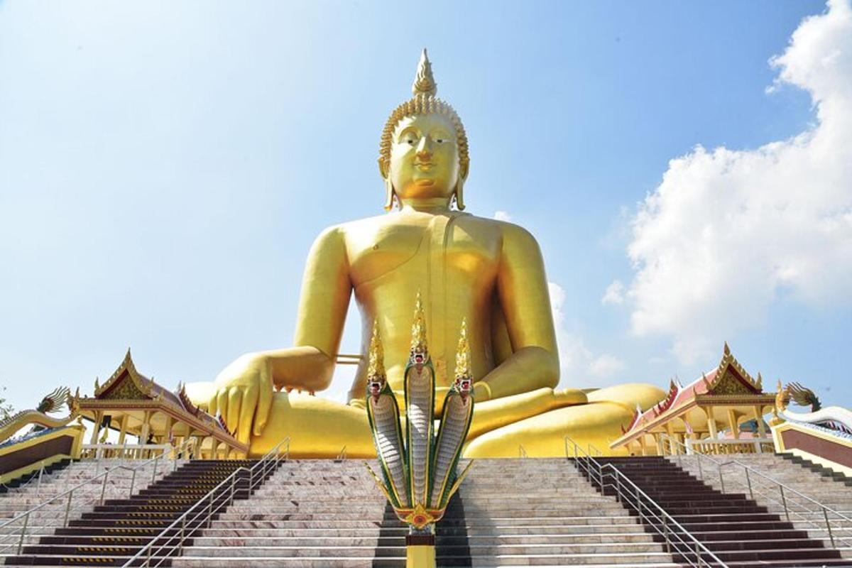 uma grande estátua dourada sentada em algumas escadas