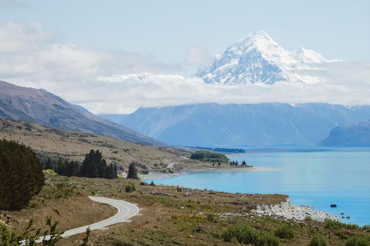 a view of a mountain and a lake with a road