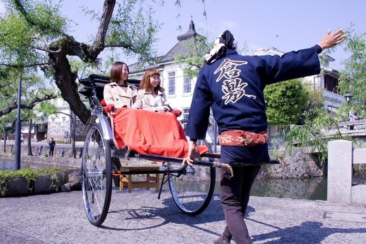 a man pulling a rickshaw with two people on it