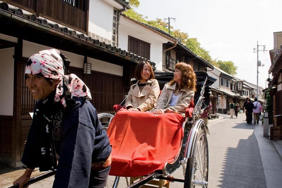 two women are riding in a rickshaw pulled