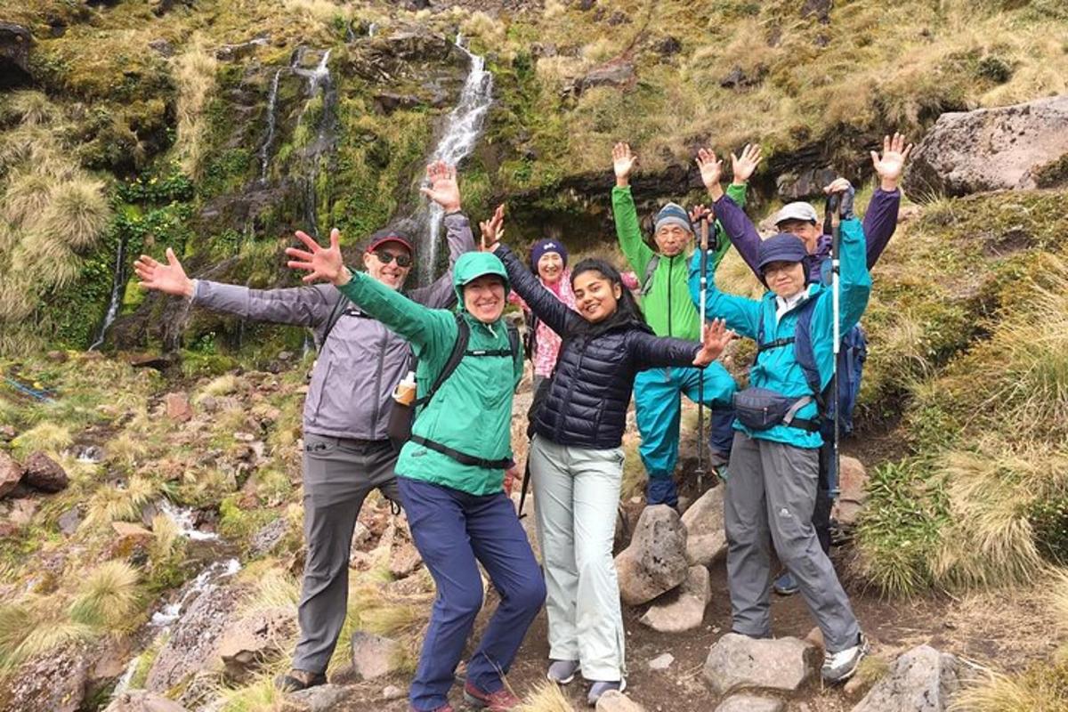 a group of people posing for a picture on a mountain