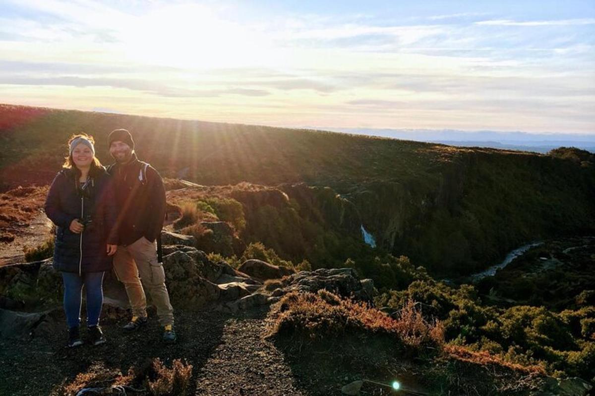 a man and a woman standing on top of a mountain