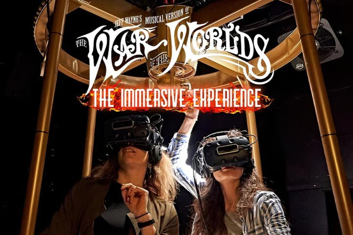 two people wearing virtual reality equipment in front of a sign